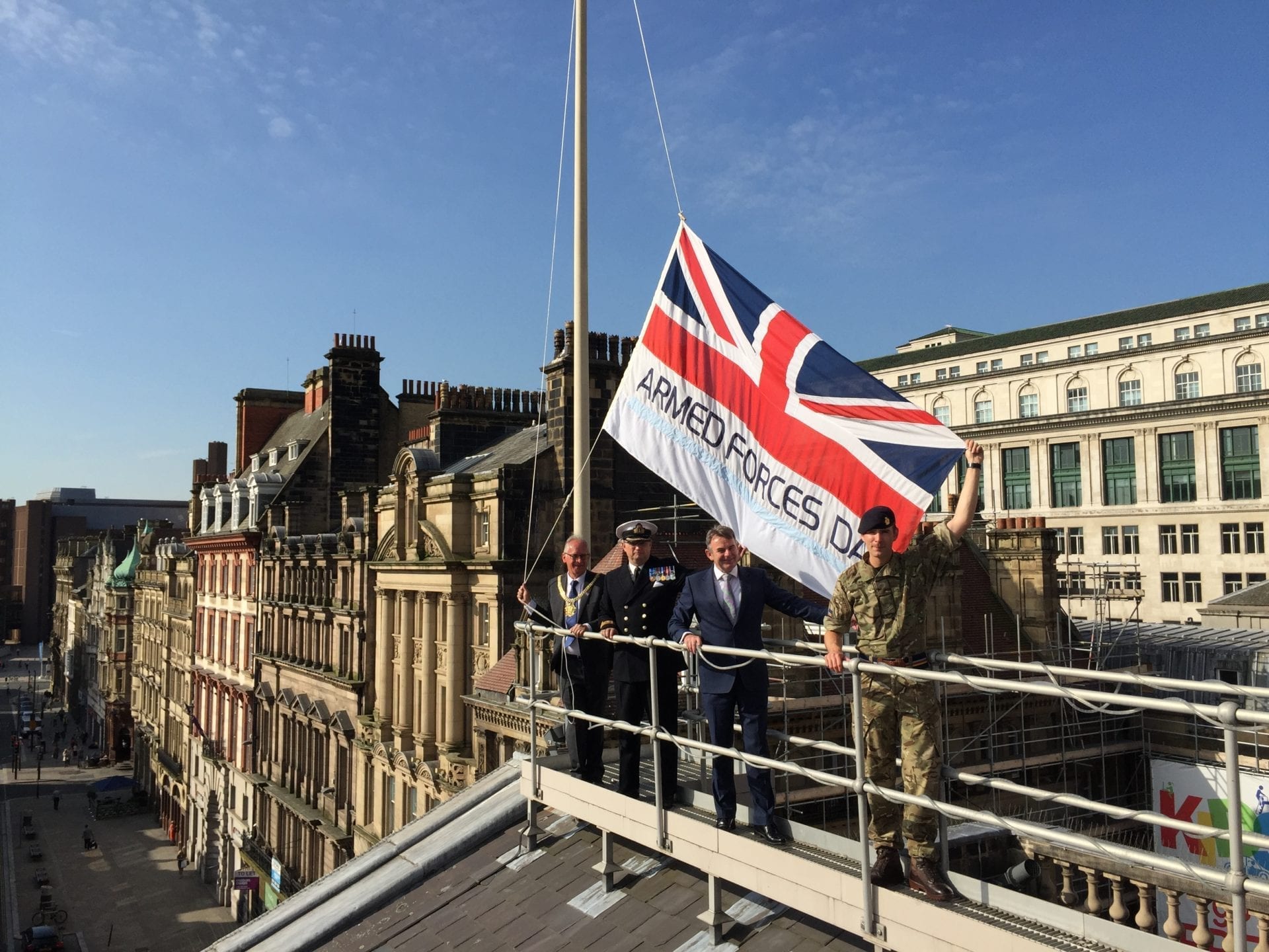 The Armed Forces Day flag rises above the Town Hall