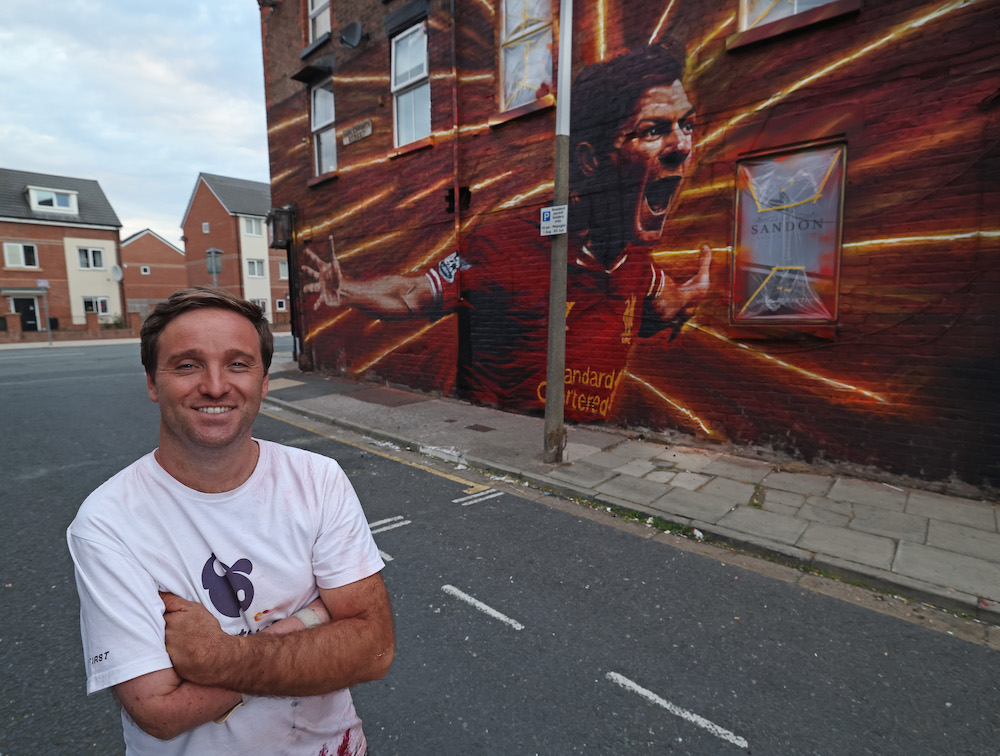 Artist John Culshaw with his finished mural of Liverpool FC legend Steven Gerrard. Picture by Gareth Jones