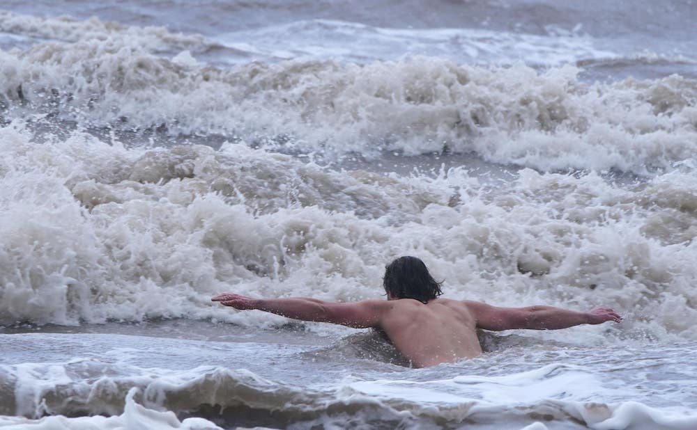 Trio defy storm warnings to strip off for sea dip in New Brighton