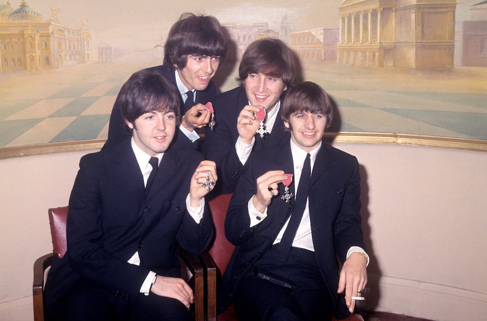 John Lennon and George Harrison are seen playing instruments for the “last recorded” Beatles song. Find out more here.