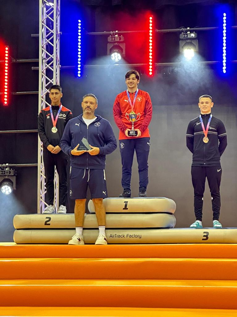 A proud Jay Scouler at the 2023 British Championships, with Zak Perzamanos behind on the winner's podium