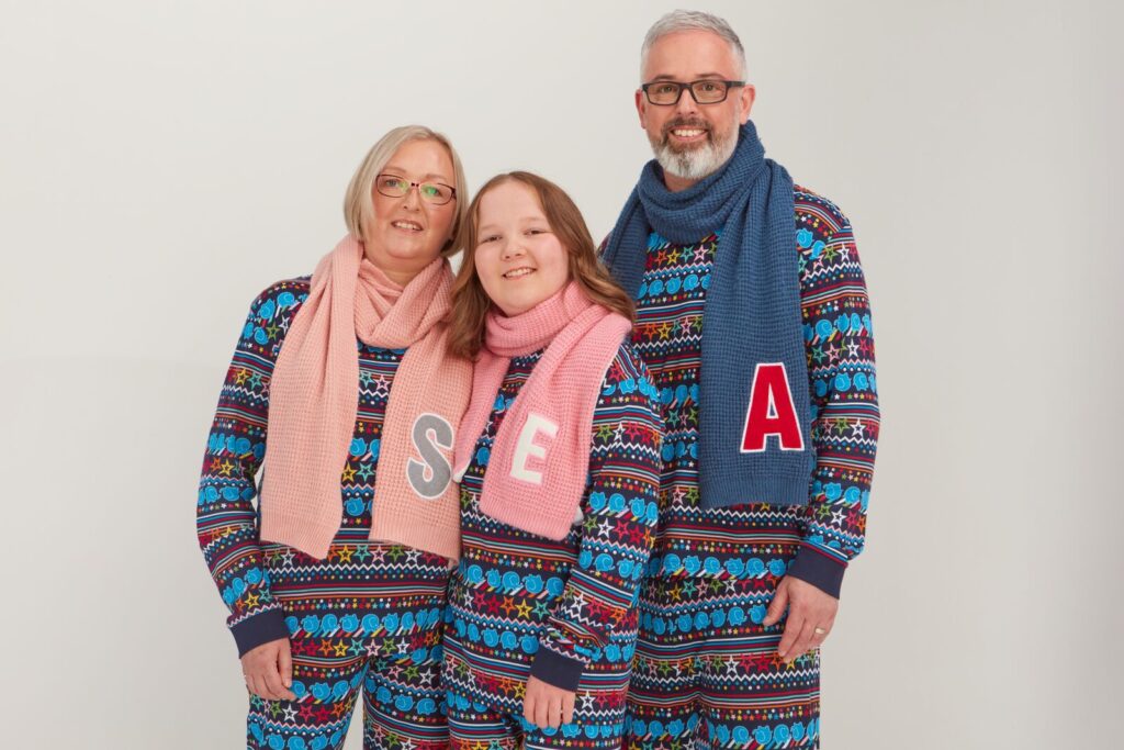 Erin Cross smiles for the camera as she and her family promote the popular Christmas PJs for Alder Hey