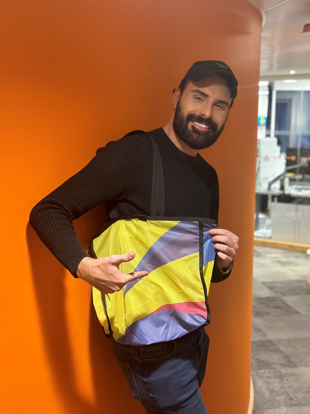 Rylan Clark with one of the Eurovision bags in support of BBC Children in Need. Credit: BBC