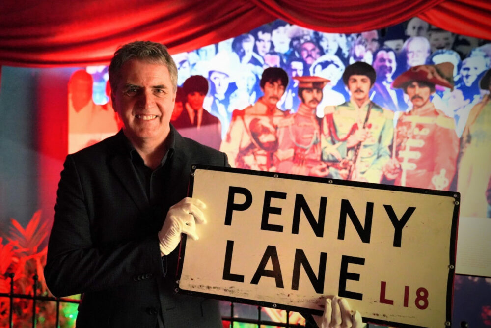 Mayor of Liverpool City Region Steve Rotheram, holding a Penny Lane street sign. Credit: PA / The Beatles Story / LCR