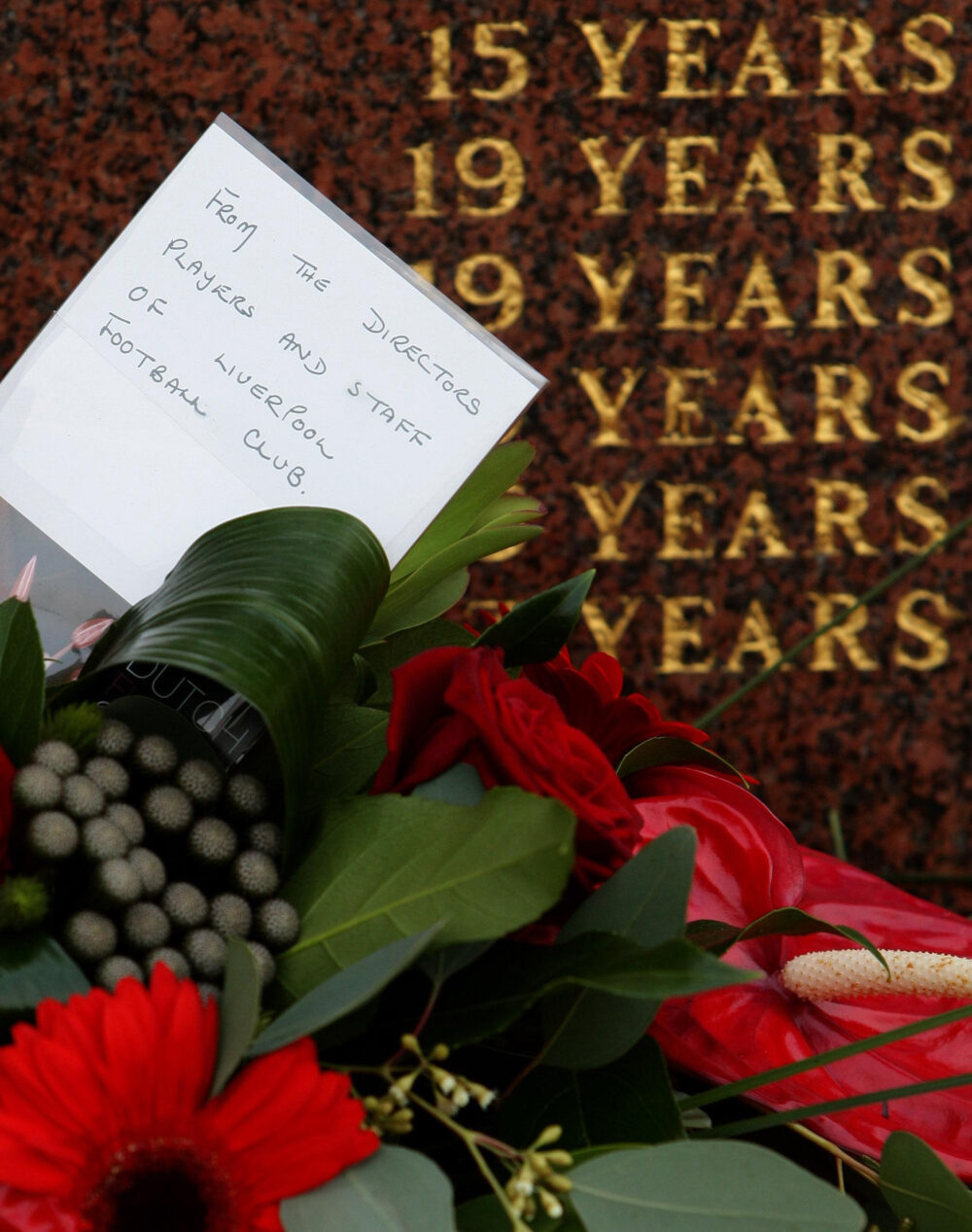 A floral tribute from Liverpool FC sits in front of the Hillsborogh Memorial before the official memorial service at Liverpool's Anfield stadium, to mark the 20th anniversary of the Hillsborough disaster in which 96 football fans died. Credit: PA