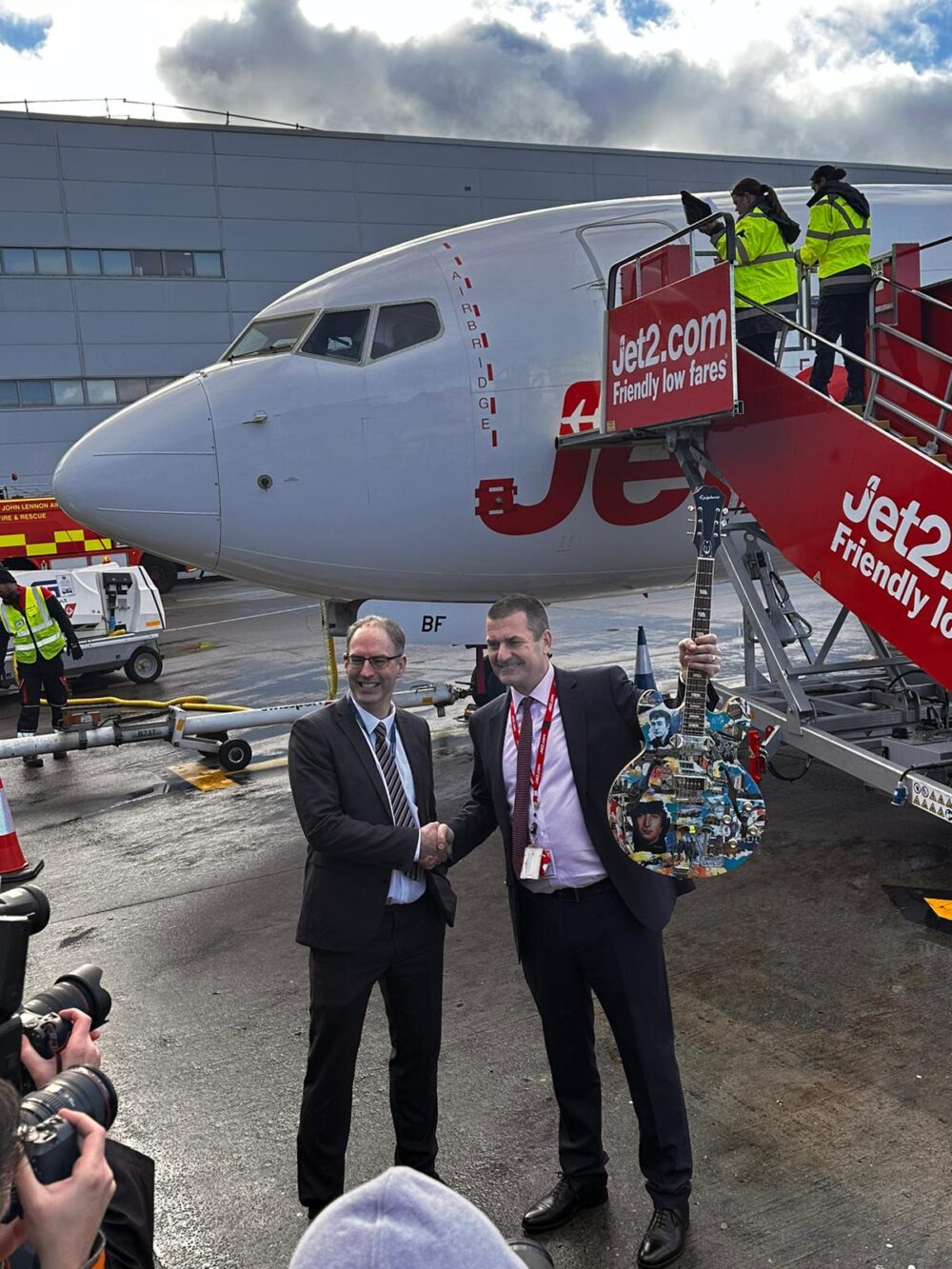 LJLA present Jet2 with a decorated guitar to symbolise Liverpool's musical heritage.
