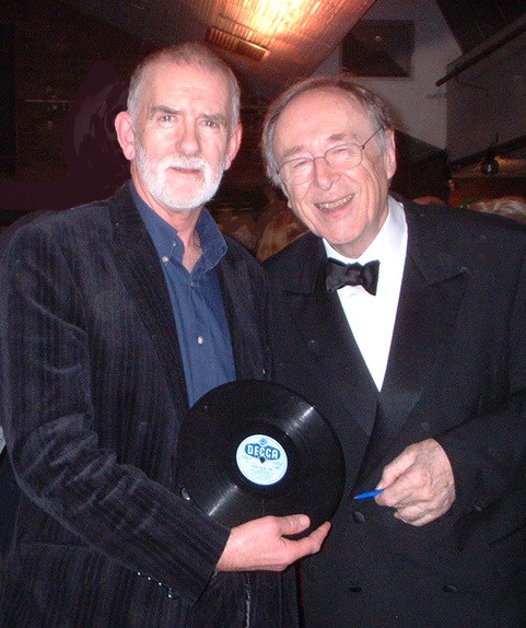 Rod Davis of The Quarrymen with Chris Barber when Chris signed John Lennon’s personal copy of Rock Island Line in 2005, now acquired permanently by the British Music Experience, Liverpool. This object is widely hailed as one of the few that represents the birth of British Popular Music. Image Credit: Janet Davis
