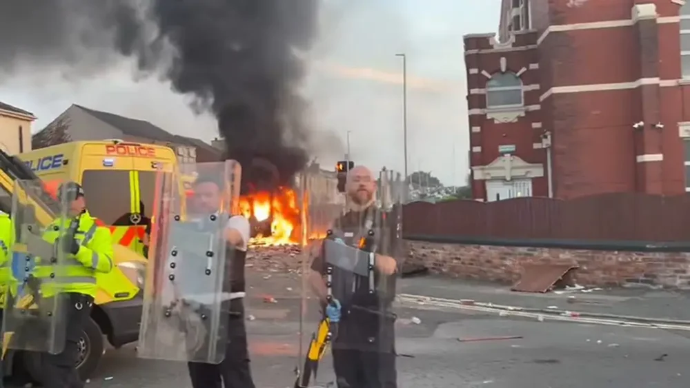 A police van set alight as trouble flares during a protest in Southport. Credit: Pat Hurst/PA