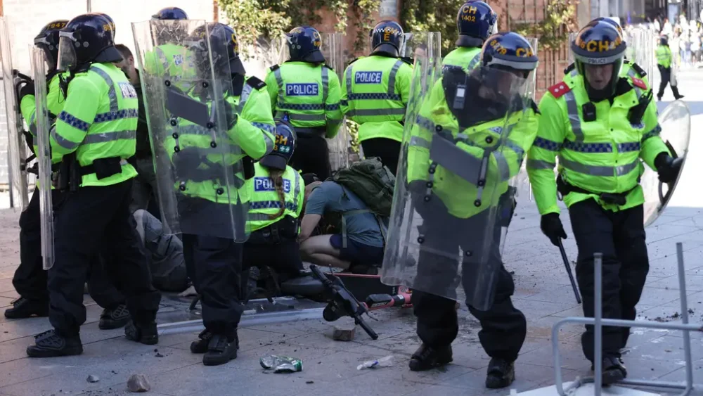 An injured man is attended to during the protests in Liverpool Credit: James Speakman/PA.