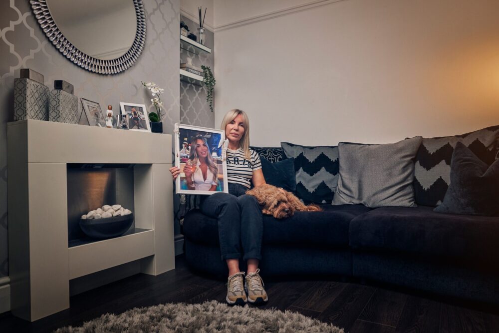 Ashley Dale's mother Julie, at home in Liverpool with a photo of Ashley. Credit: Merseyside Detectives.