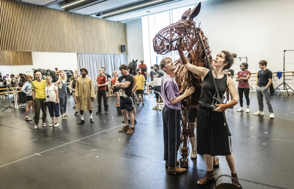 Tom Sturgess, Alexandra Donnachie and the cast of War Horse in rehearsals. Credit Pamela Raith Photography