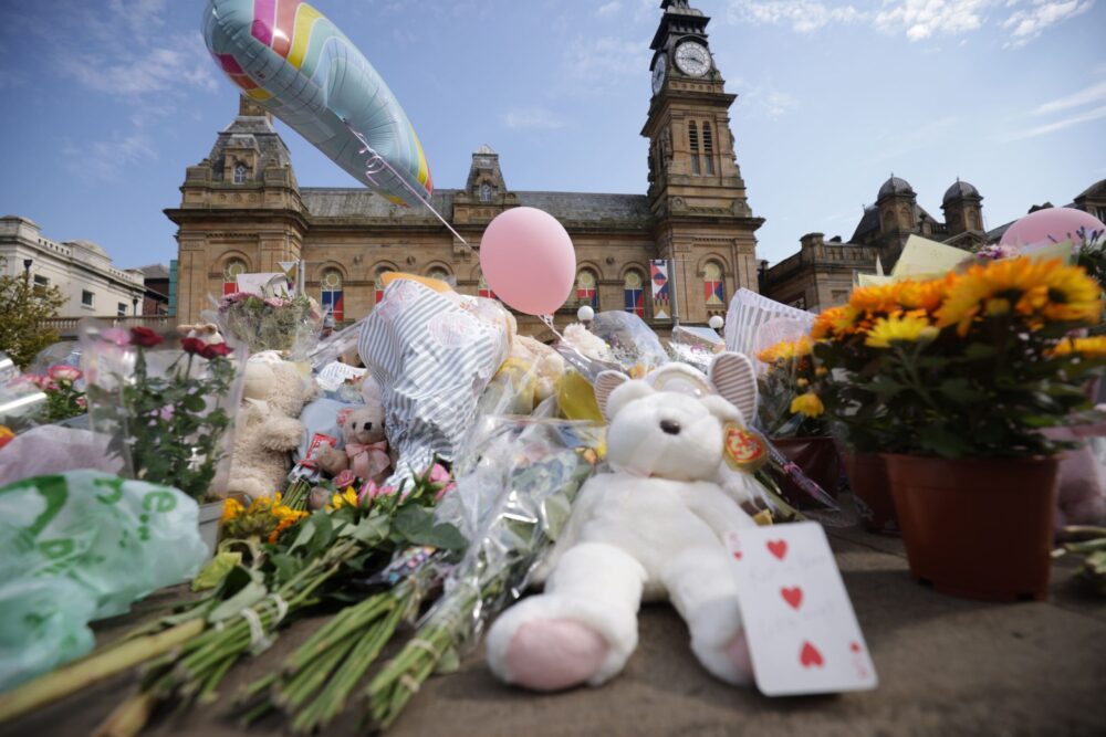 Floral tributes have been left outside Atkinson Art Centre in Southport to those killed and injured in the attack. Credit: PA