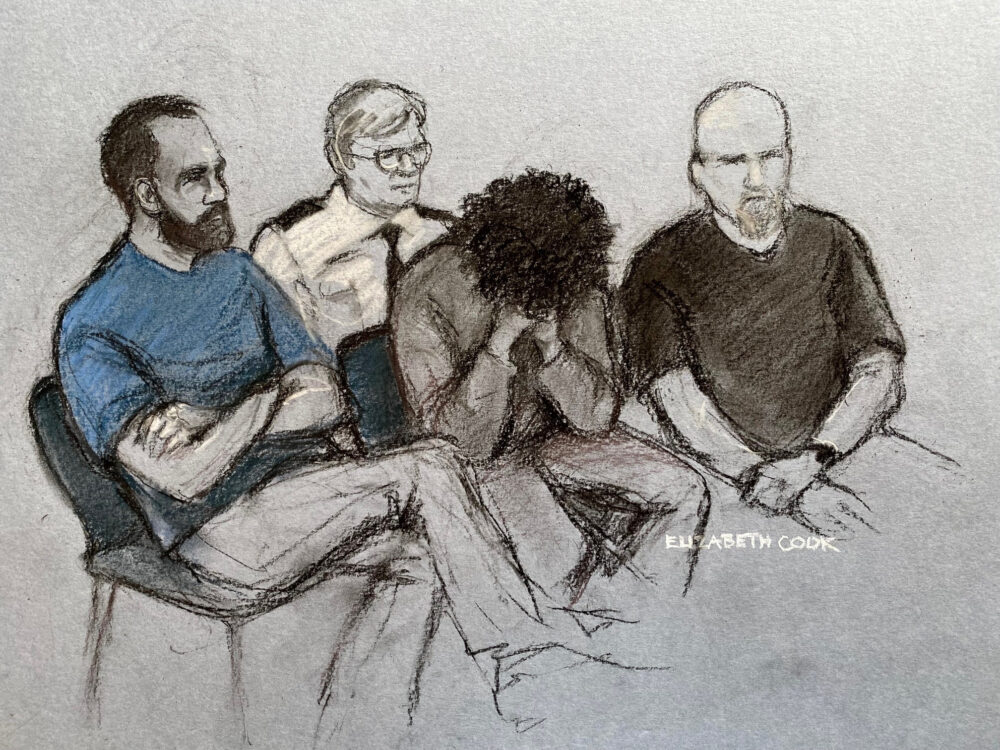 A court sketch of 17-year-old Axel Rudakubana (centre) covering his face as he appeared in the dock at Liverpool Crown Court Credit: Elizabeth Cook/PA