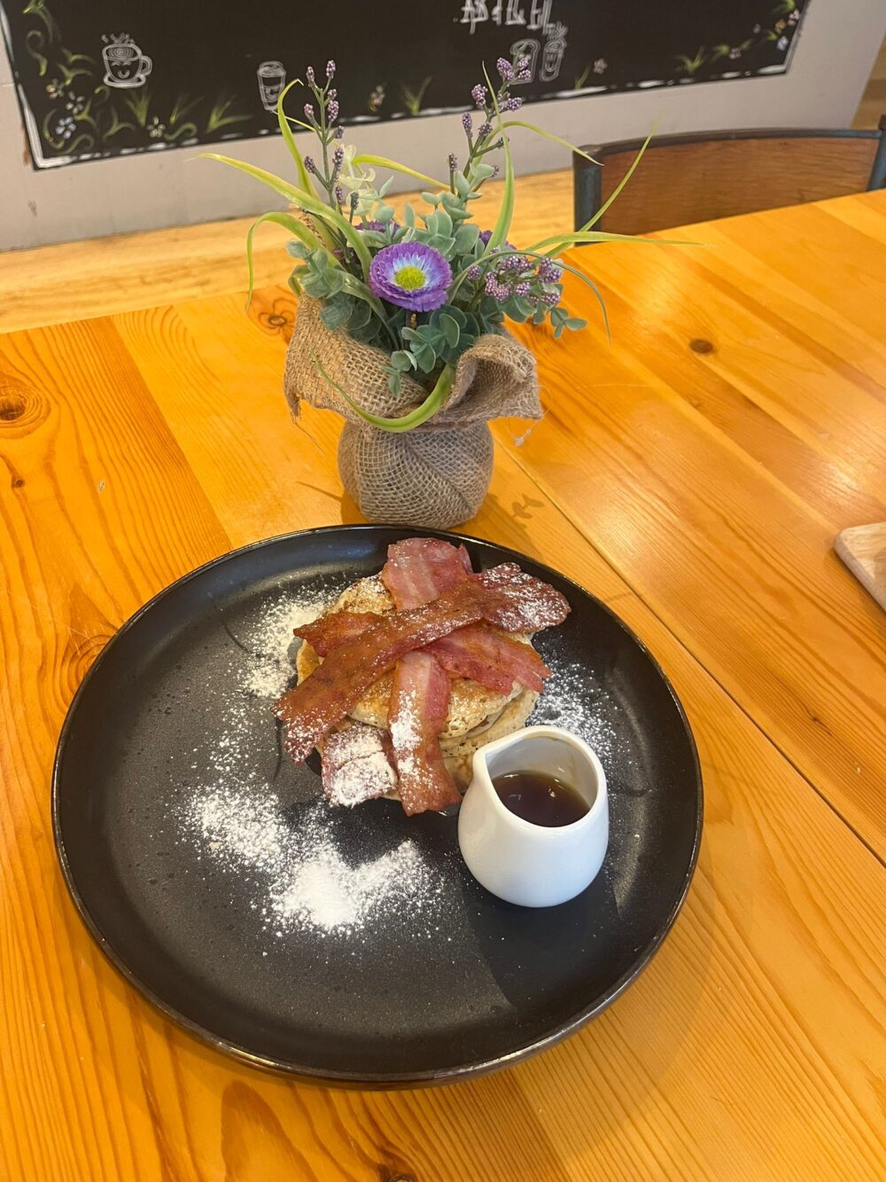 Paper Cup Coffee's pancake stack with crispy bacon and maple syrup