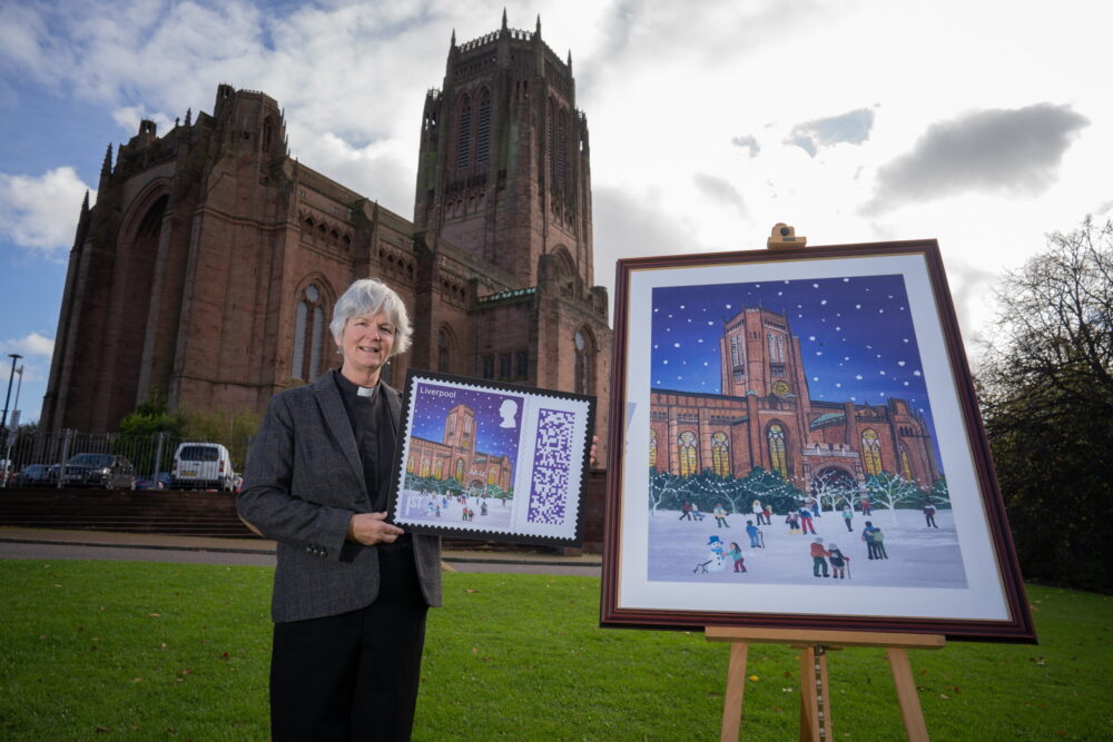 The Very Reverend Dr Sue Jones outside Liverpool Cathedral with the Christmas stamp 2024.