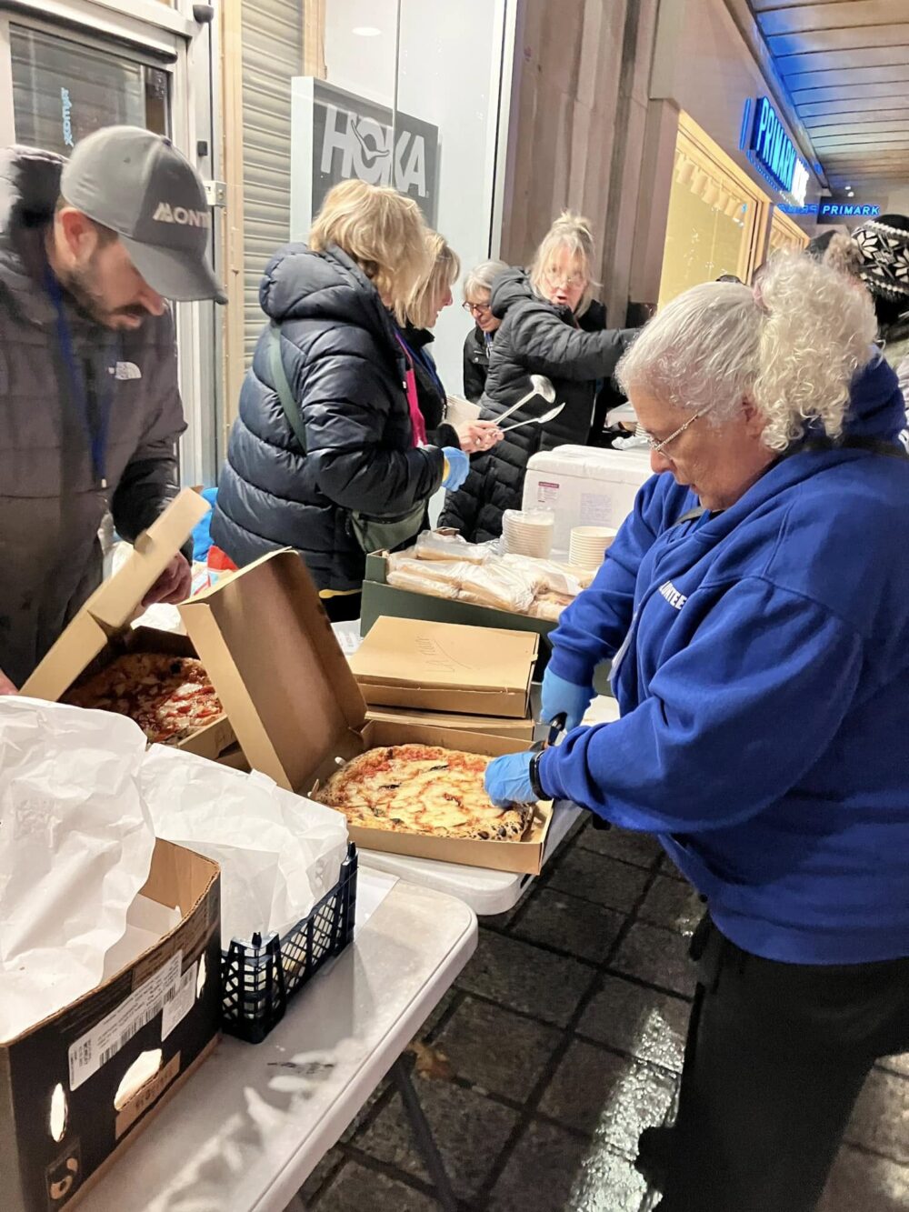 Liverpool In Arms team preparing to hand out donated pizzas