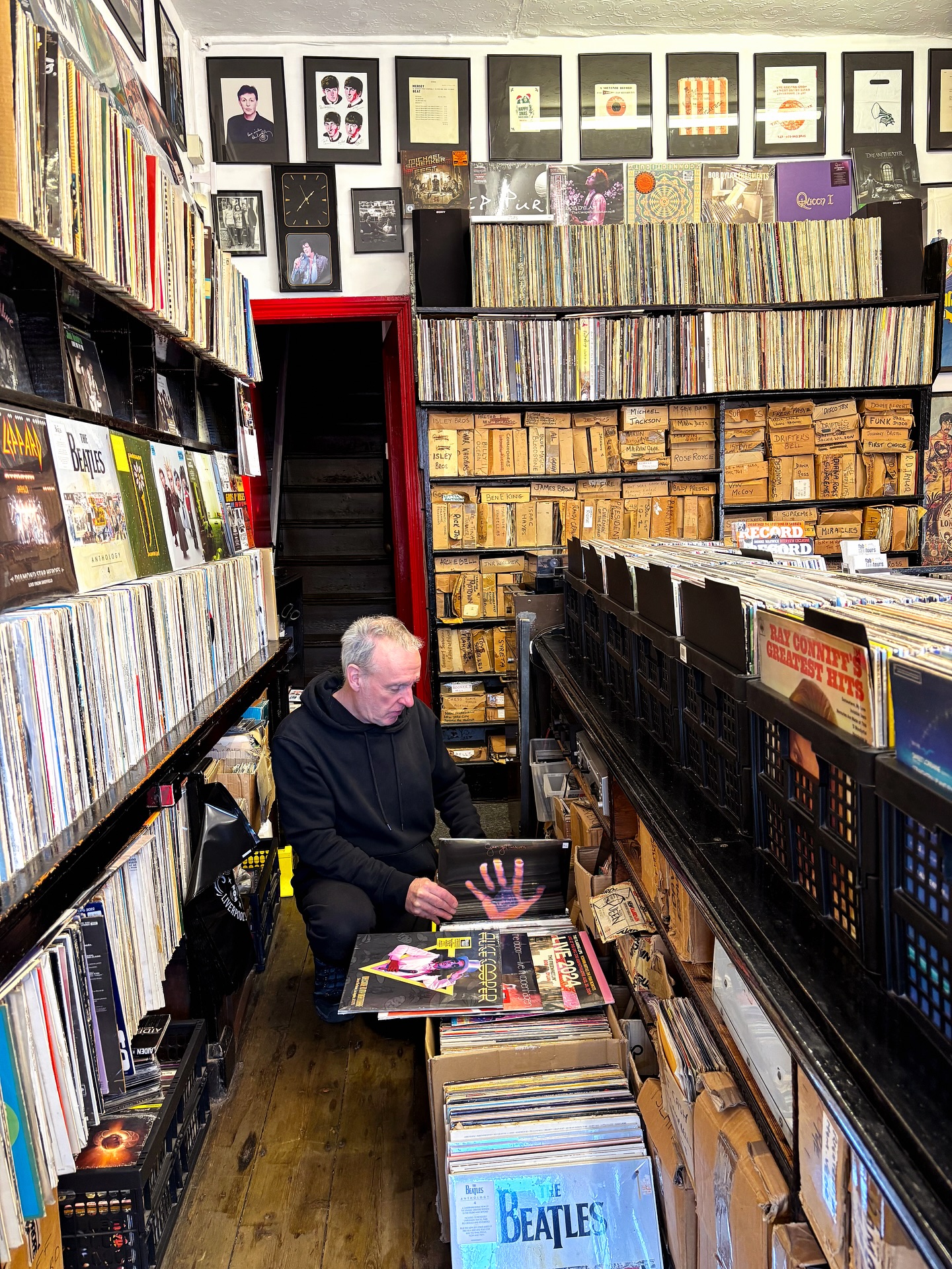 Tony surrounded by vinyl in The Musical Box