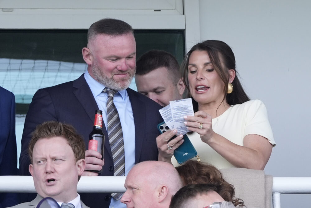 Credit: Peter Byrne / PA Wayne Rooney and Coleen Rooney in the grandstand during the William Hill Handicap Hurdle on Grand National Day of the Randox Grand National Festival 2026 at Aintree Racecourse. Picture date: Saturday April 11, 2026.